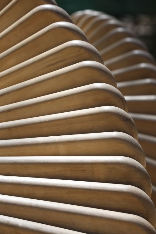Free Close-up of spiral wooden bench design capturing its abstract construction and texture. Stock Photo