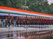 Military parade during Indian Independence Day in heavy rain, showcasing discipline and patriotism.