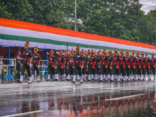 Free Military parade during Indian Independence Day in heavy rain, showcasing discipline and patriotism. Stock Photo