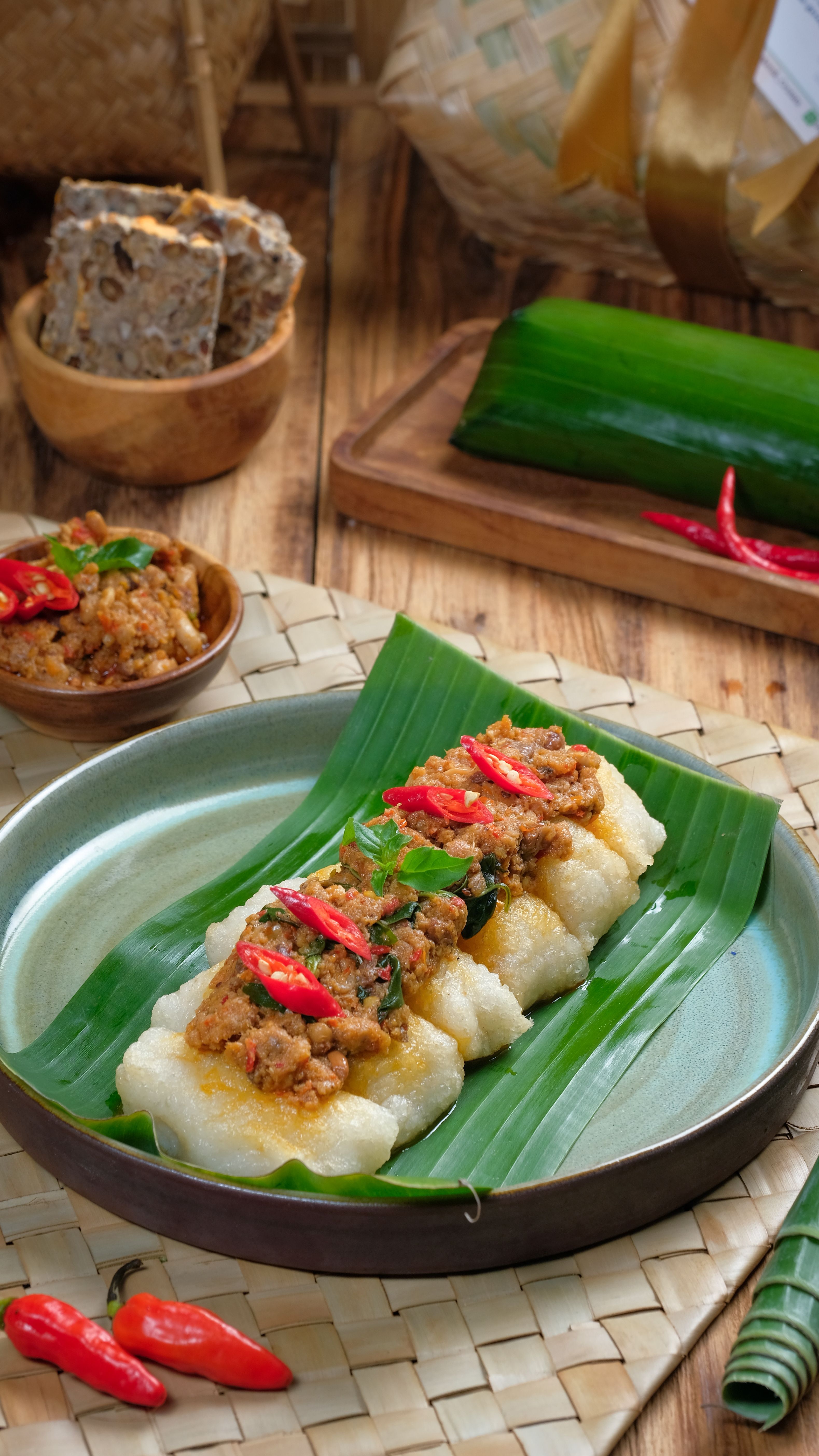 Traditional Sundanese food served on a banana leaf with chili garnish, showcasing authentic Indonesian flavors.