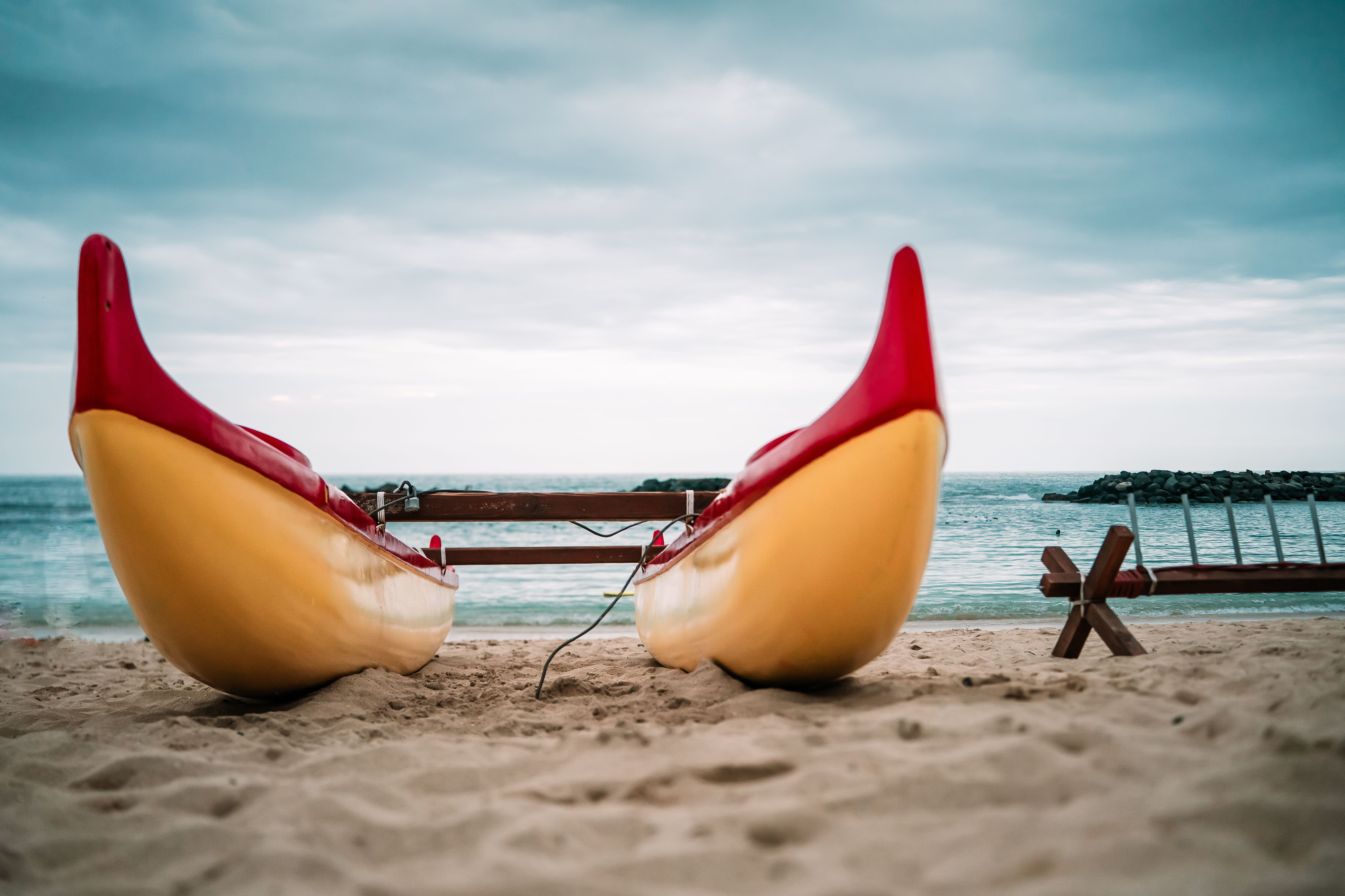 A bright canoe on the calm white sand of a Ko Olina beach, west Oahu