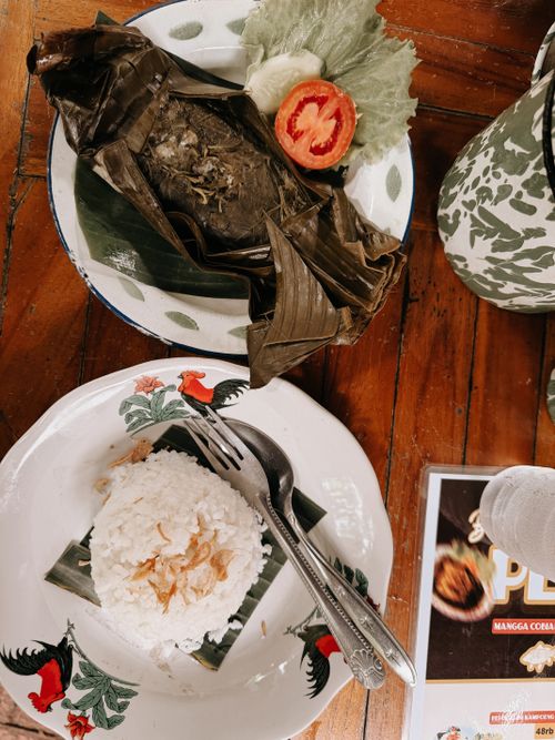 Free Authentic Indonesian meal with rice and banana leaf-wrapped dish from Garut, West Java. Stock Photo