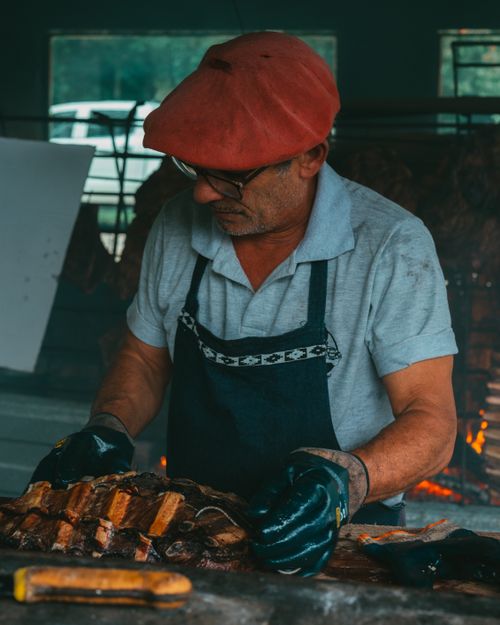 Free A man grilling meat during an authentic Argentine asado in Uribelarrea, Buenos Aires Province. Stock Photo