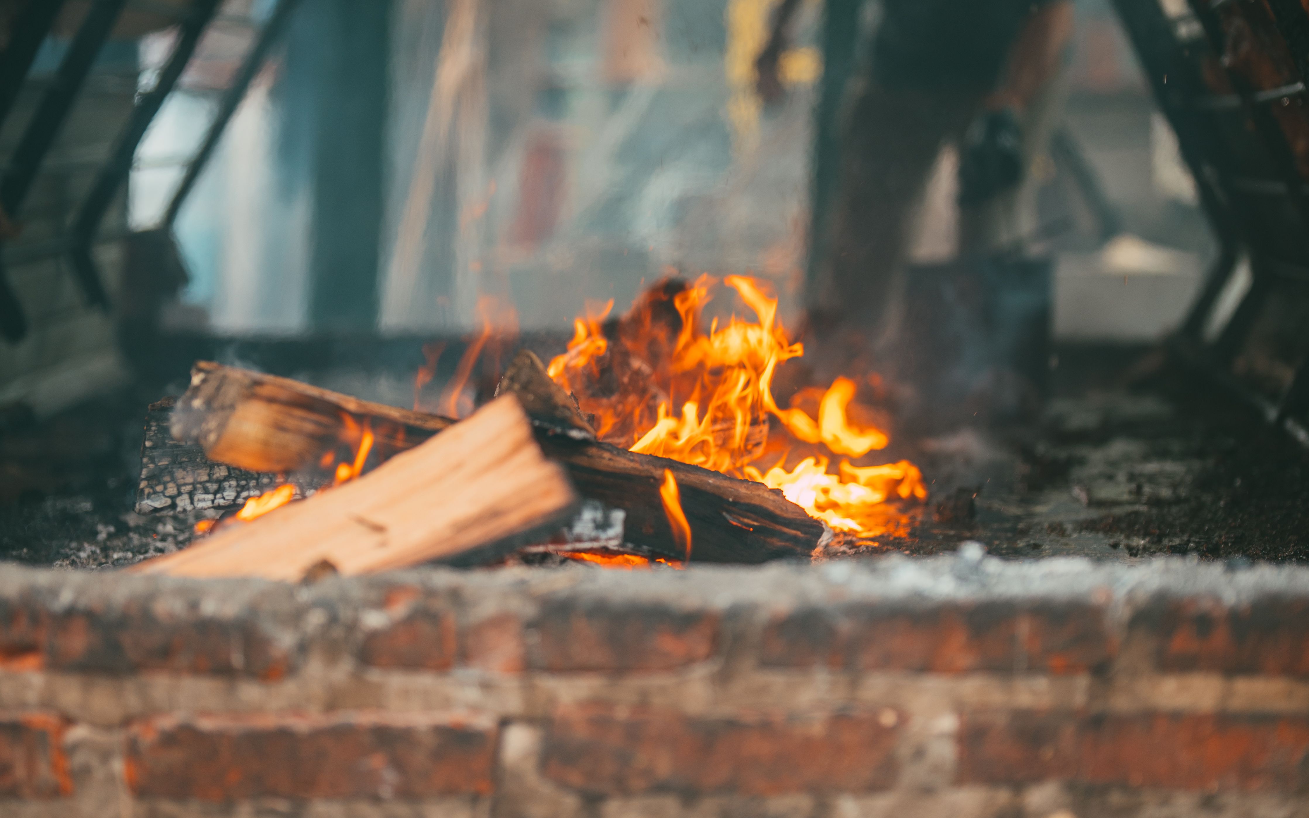 Captivating fire burning in a rustic outdoor brick fireplace — firebricks are required for a firebox that survives thermal cycling