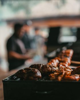 Traditional Argentine barbecue preparation with grilled meats at Uribelarrea market.