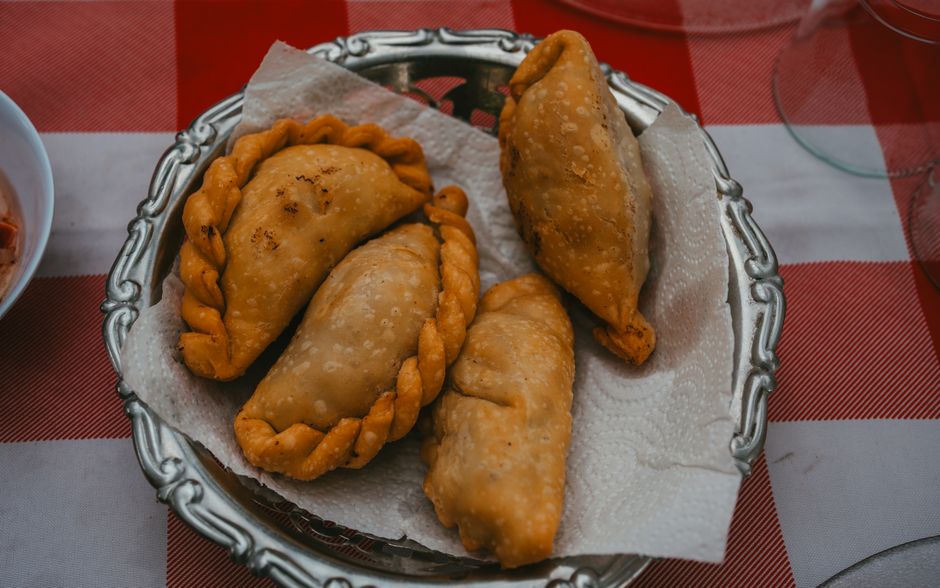 Freshly baked Pastizzi, a traditional Maltese savory pastry, displayed at a local shop.