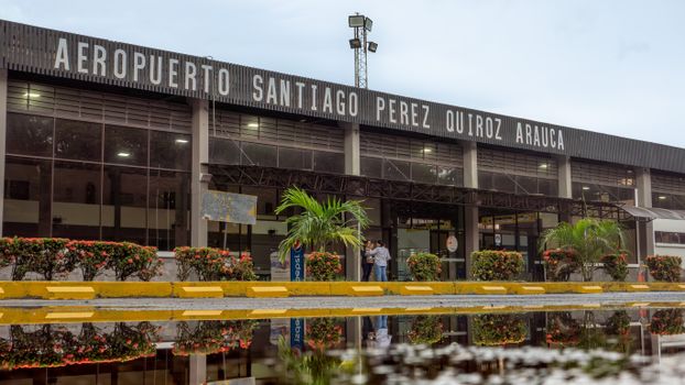 Exterior view of Santiago Perez Quiroz Airport in Arauca, Colombia, with reflection in a puddle.