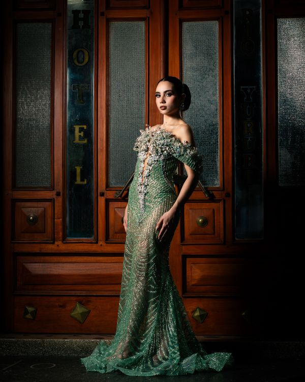 Woman wearing emerald wrap midi dress