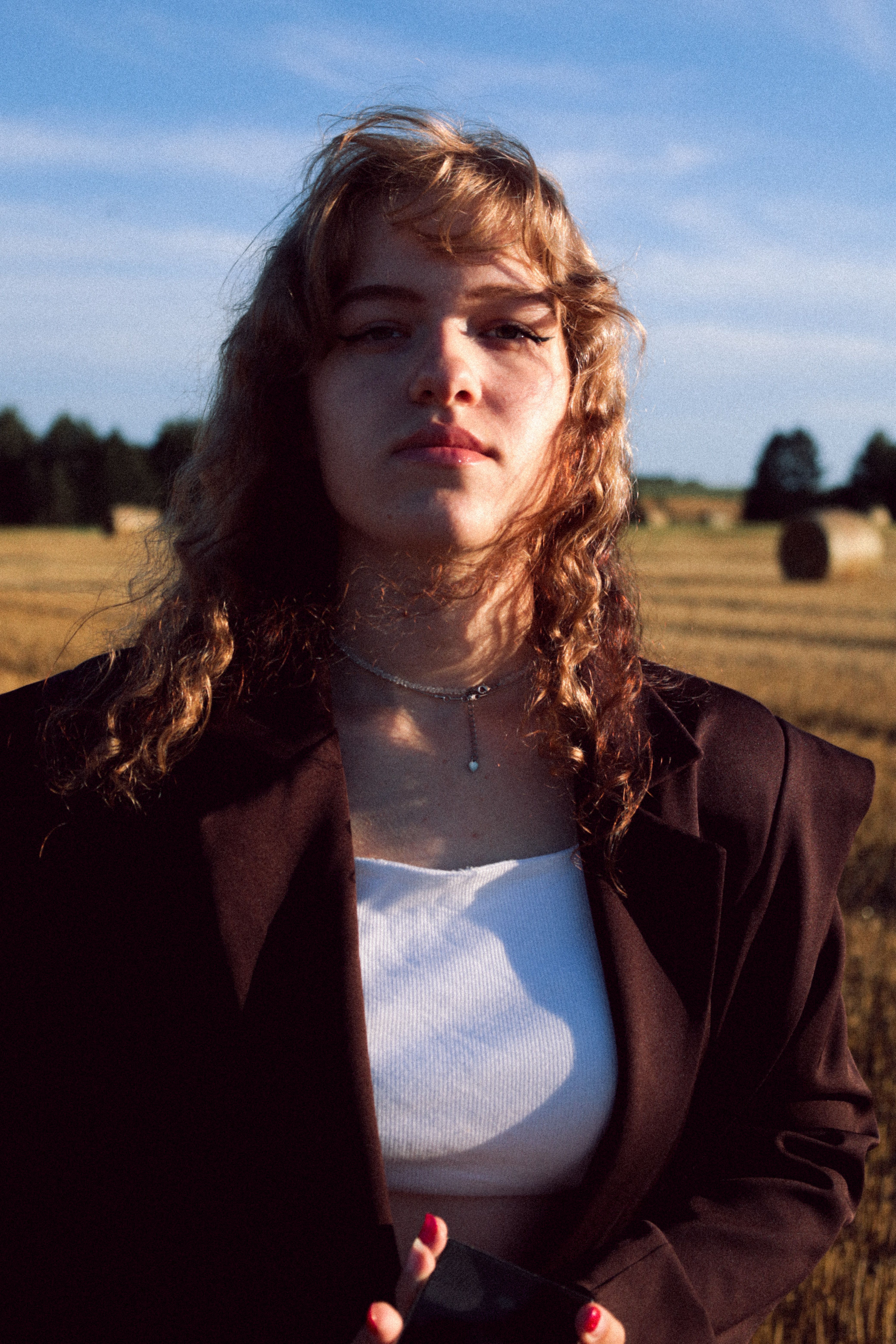 Young Woman in Field at Sunset · Free Stock Photo