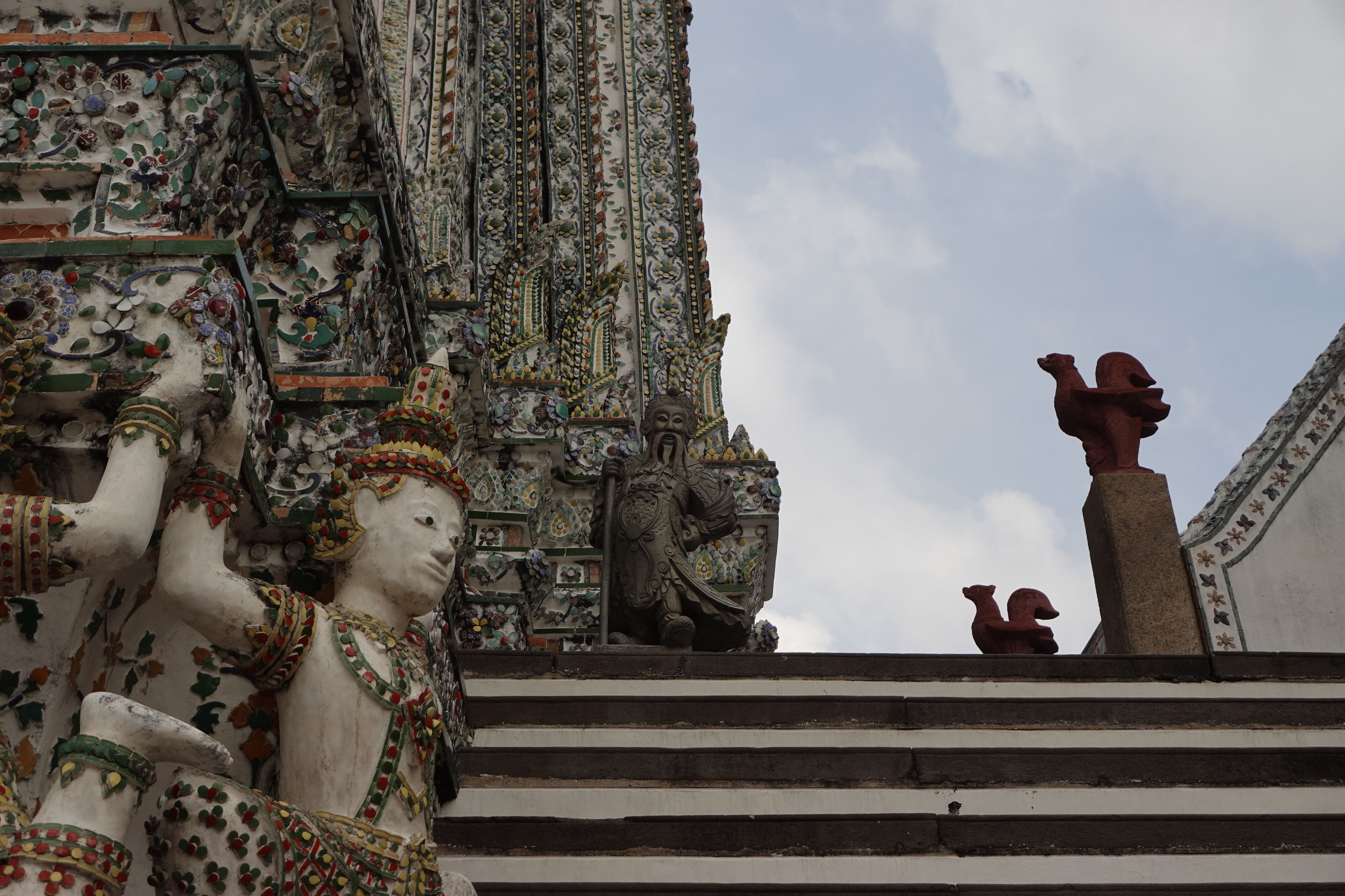 Close-up of Wat Arun's ornate architecture showcasing traditional Thai decorative elements in Bangkok, Thailand.