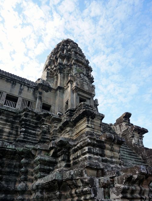 Free Stunning view of Angkor Wat temple showcasing ancient Khmer architecture beneath a blue sky. Stock Photo