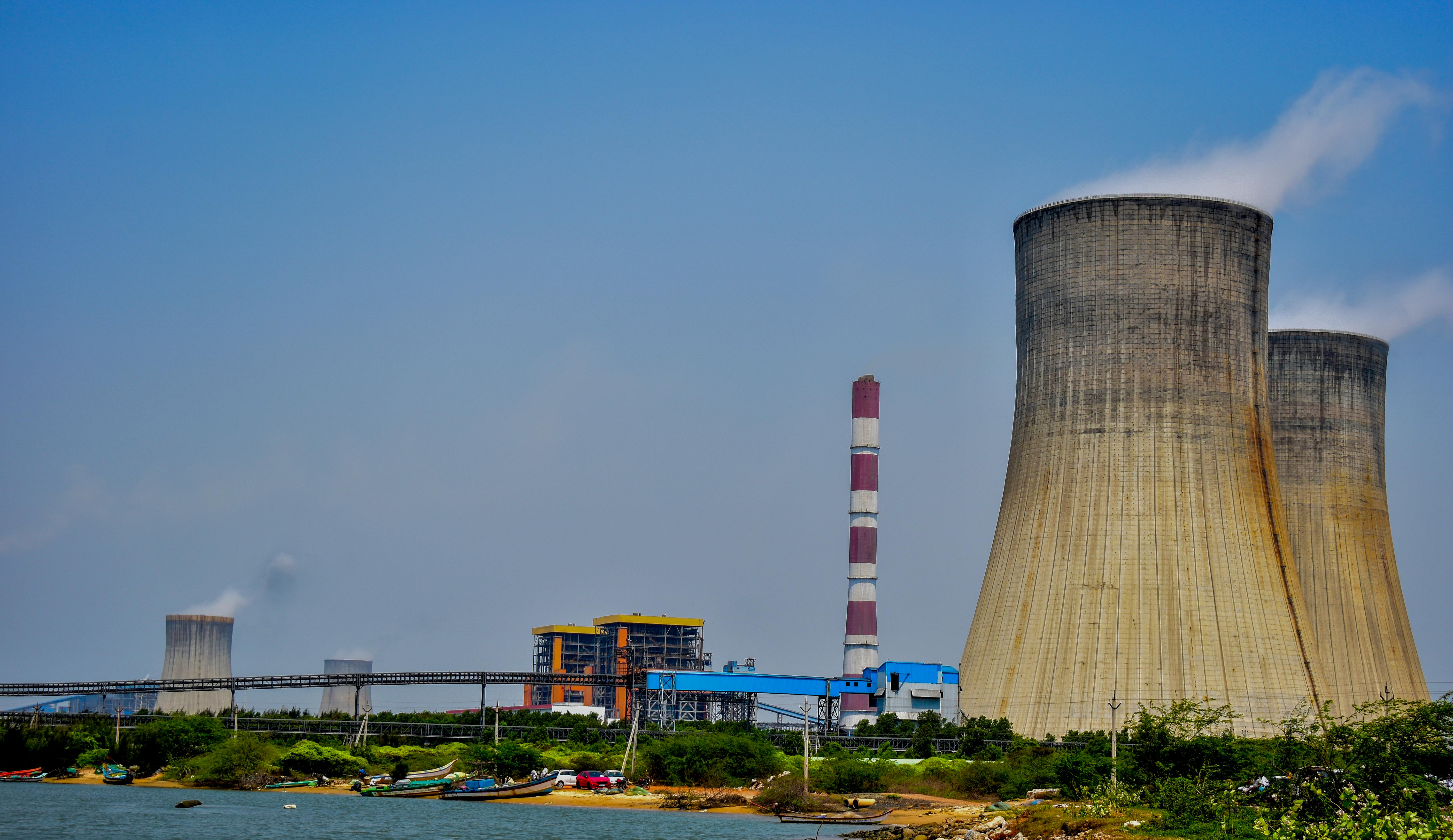 Cooling towers at a thermal power plant in Nellore, Andhra Pradesh, India on a clear day.