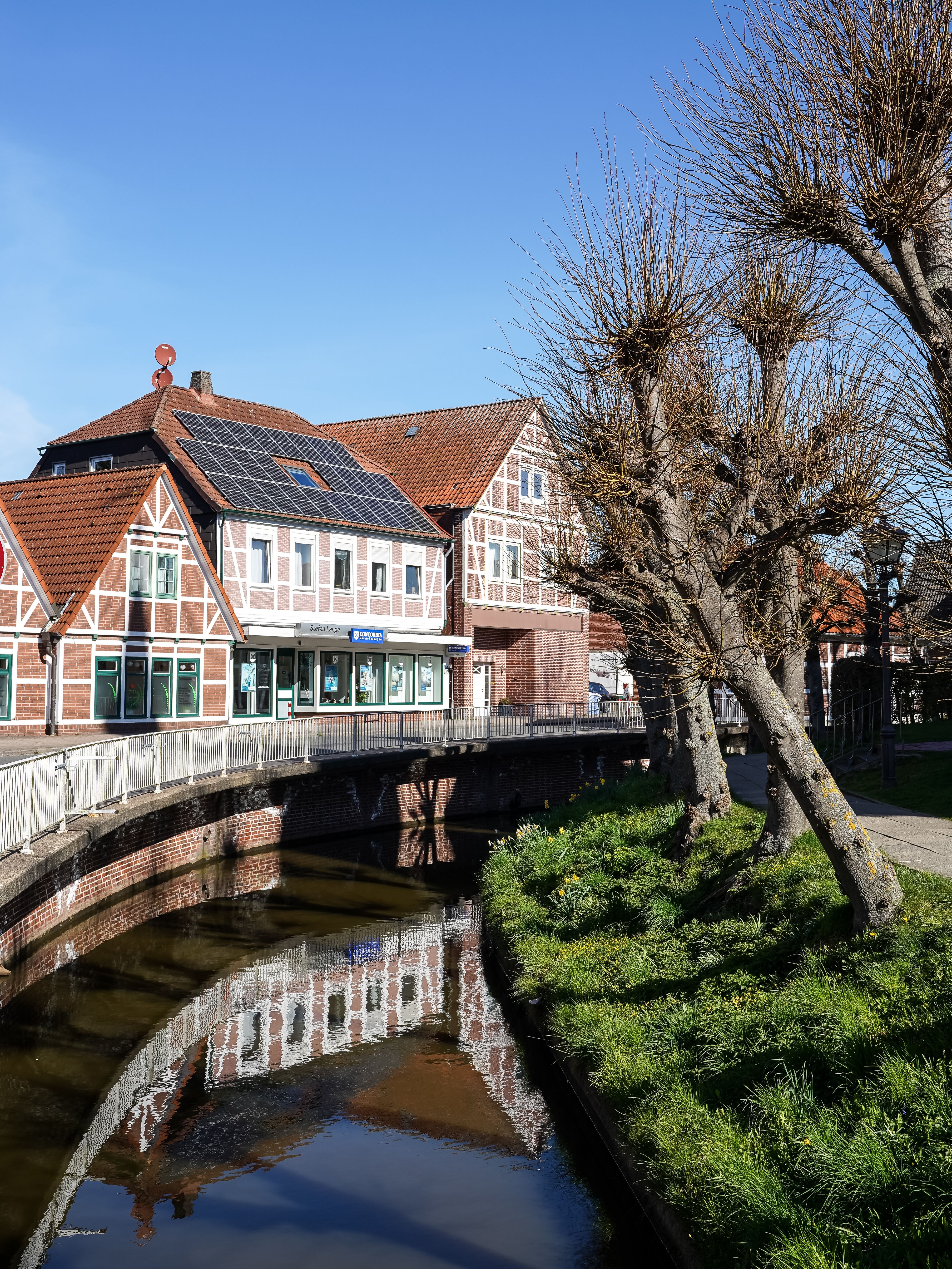 A picturesque view of timbered houses alongside a canal in York, England, on a sunny day.