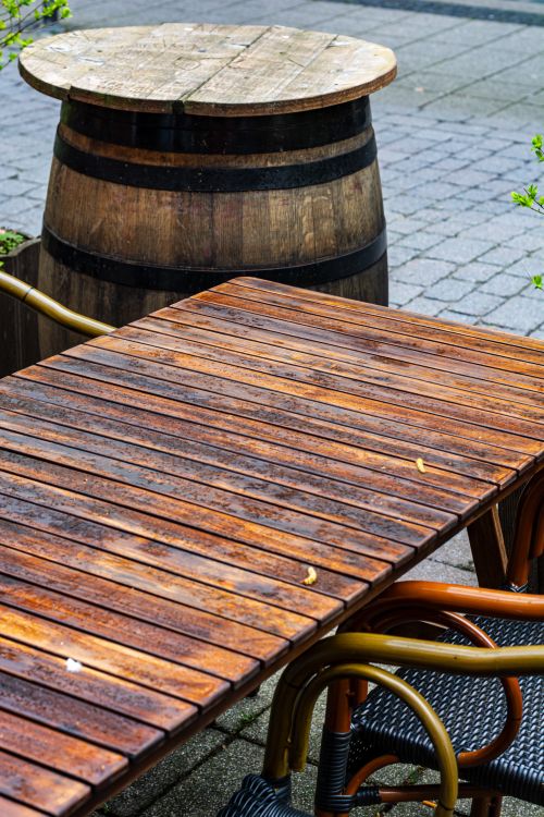 Free A cozy outdoor seating area featuring a wooden table and barrel in Coesfeld, Germany. Stock Photo