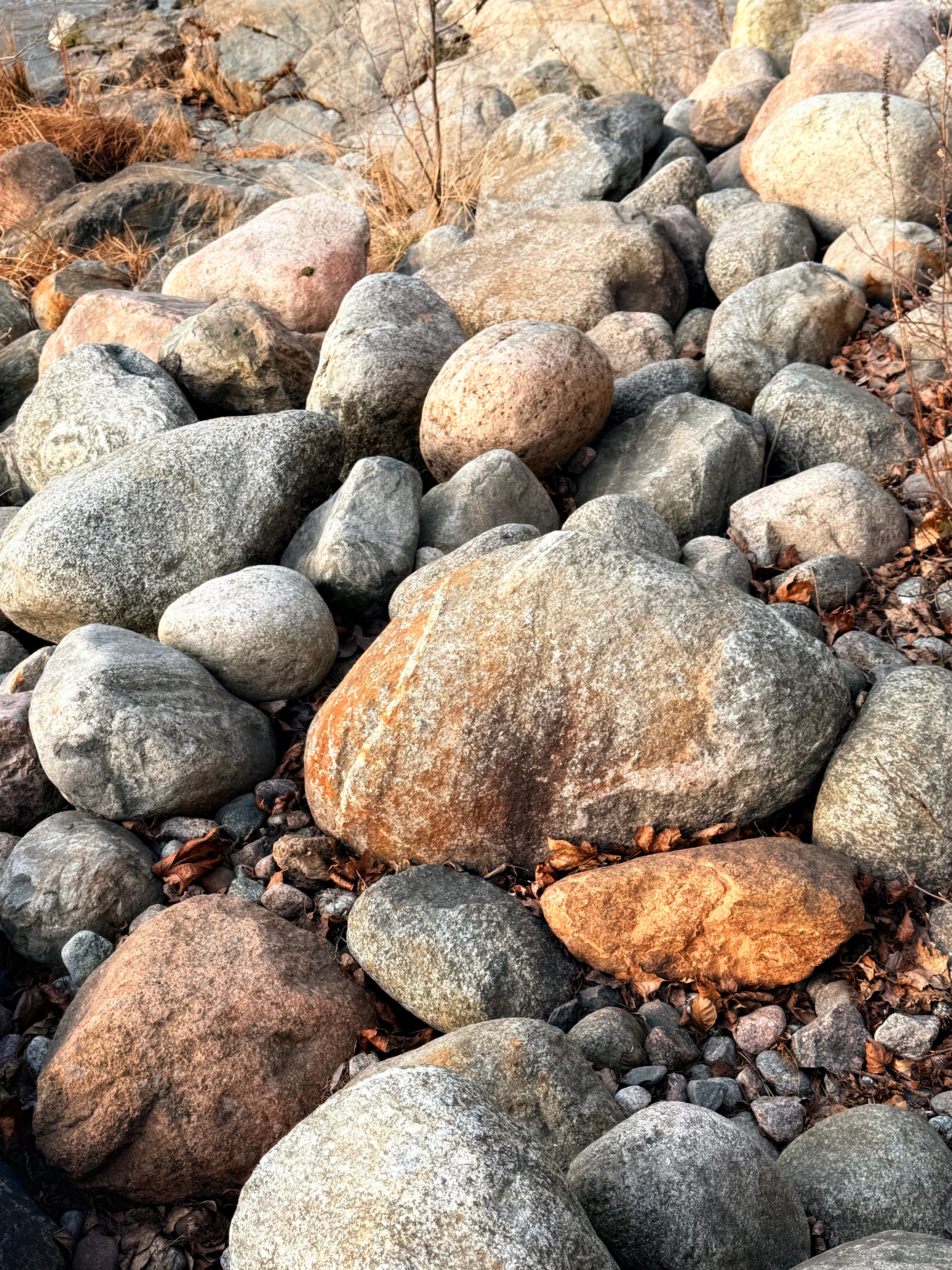 Granite rocks clustered in a natural formation in Vantaa, Finland, during daylight.