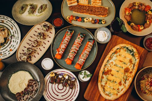 A top-down view of various gourmet dishes beautifully plated, showcasing a variety of colors and culinary styles.