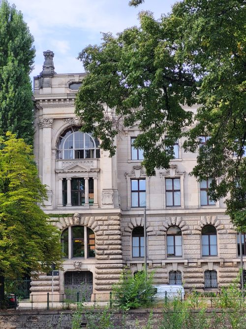 Free Classic architecture building in Berlin framed by vibrant trees, captured on a sunny day. Stock Photo