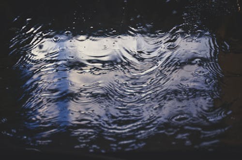 Free Water Droplets In Flowing Water Stock Photo