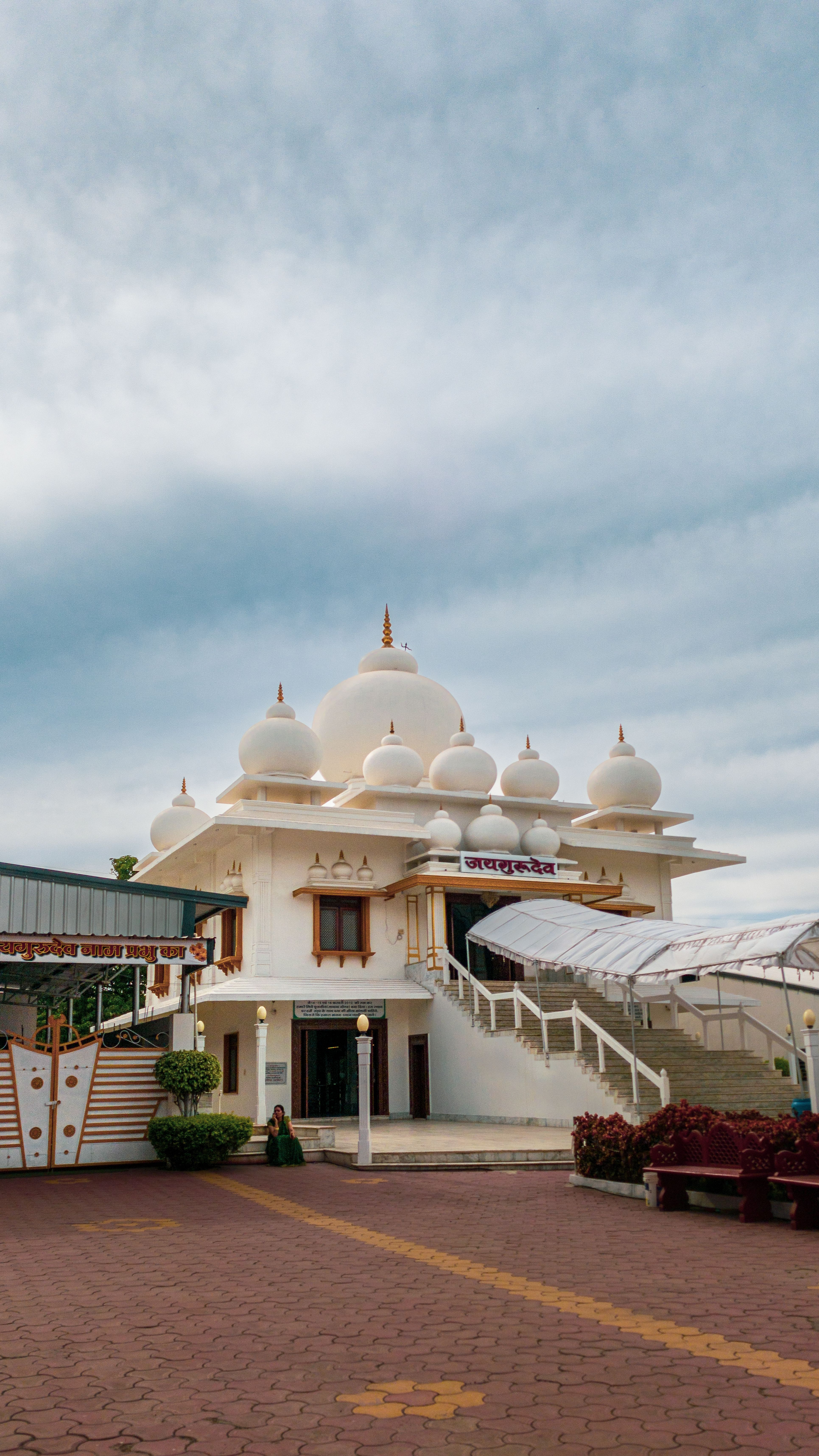 Elegant white temple with domes on a sunny day in Mirjapur, India.