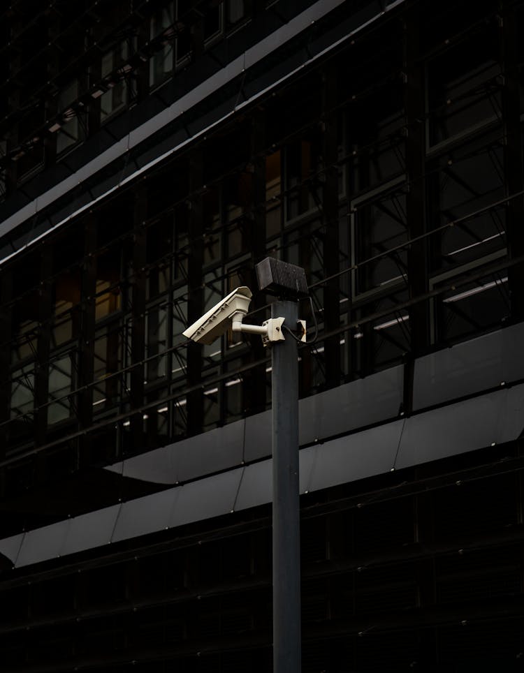 CCTV Camera On A Post Outside A Building