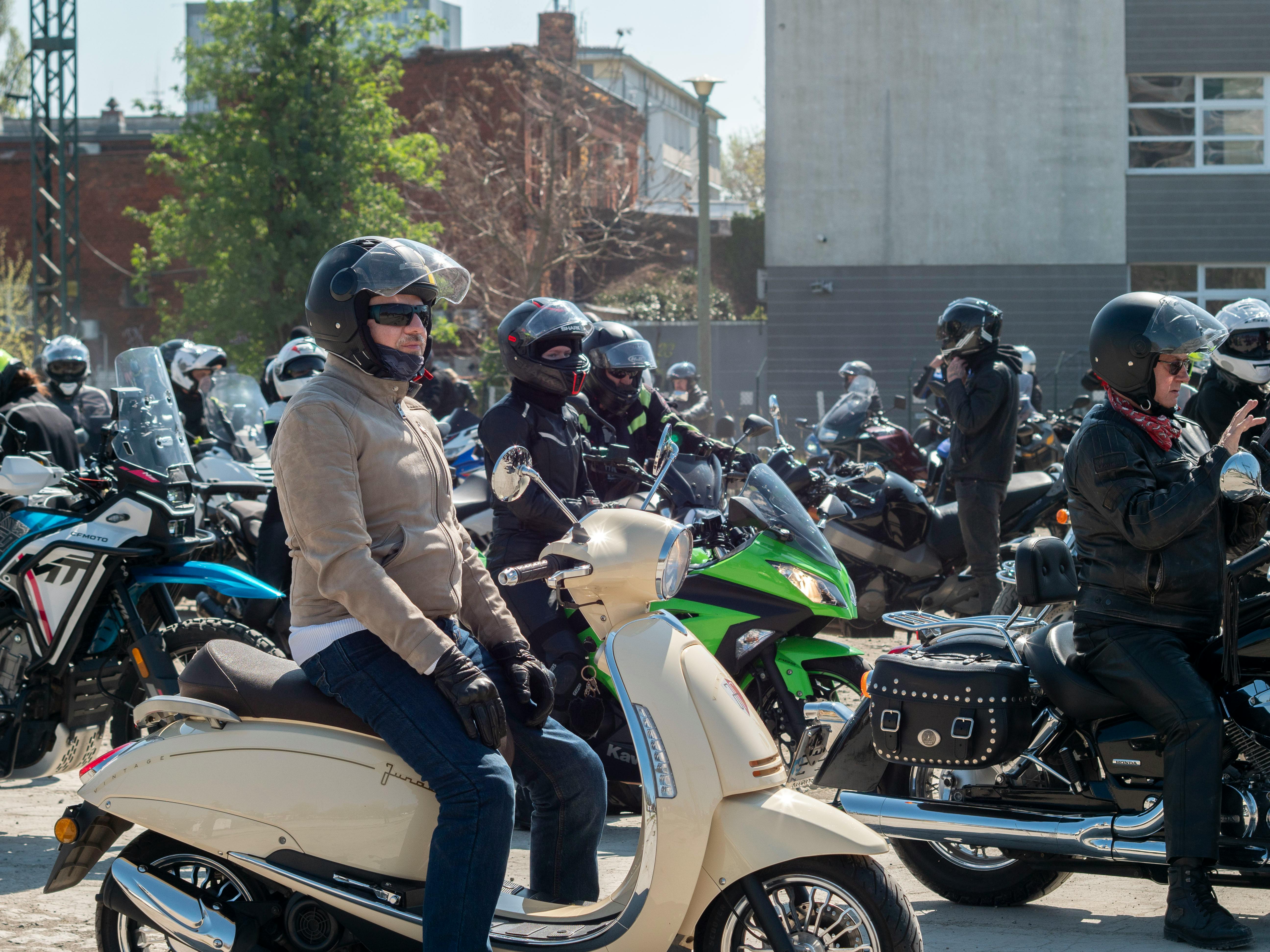 Large group of motorcyclists gathered outdoors in Wrocław, Poland, showcasing diverse bikes and riders.