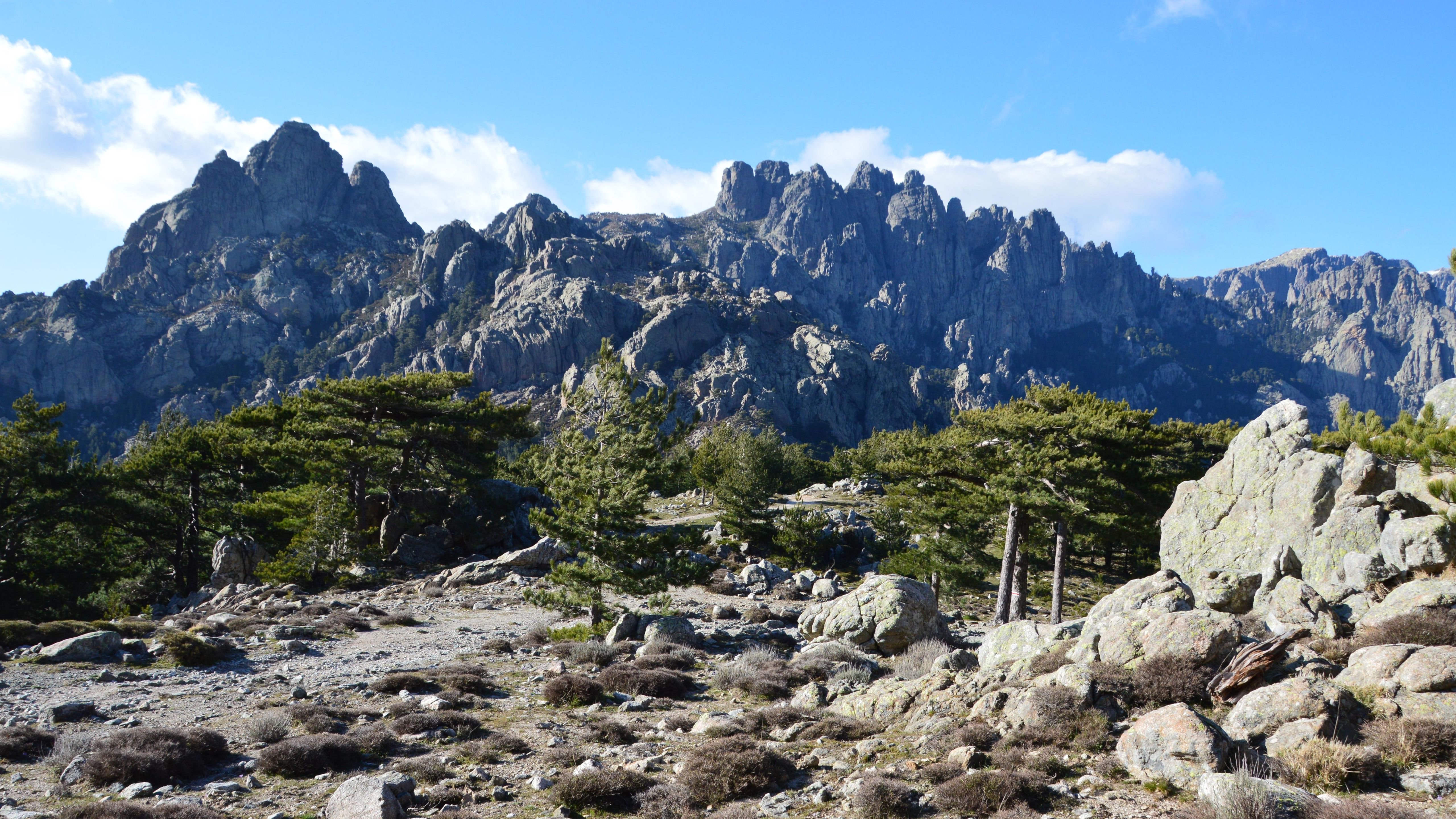 Stunning mountain landscape in Zonza, Corsica, under a bright blue sky.