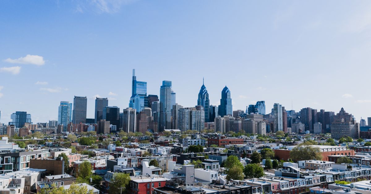 Majestic Philadelphia skyline under a clear blue sky, captured from an elevated perspective.