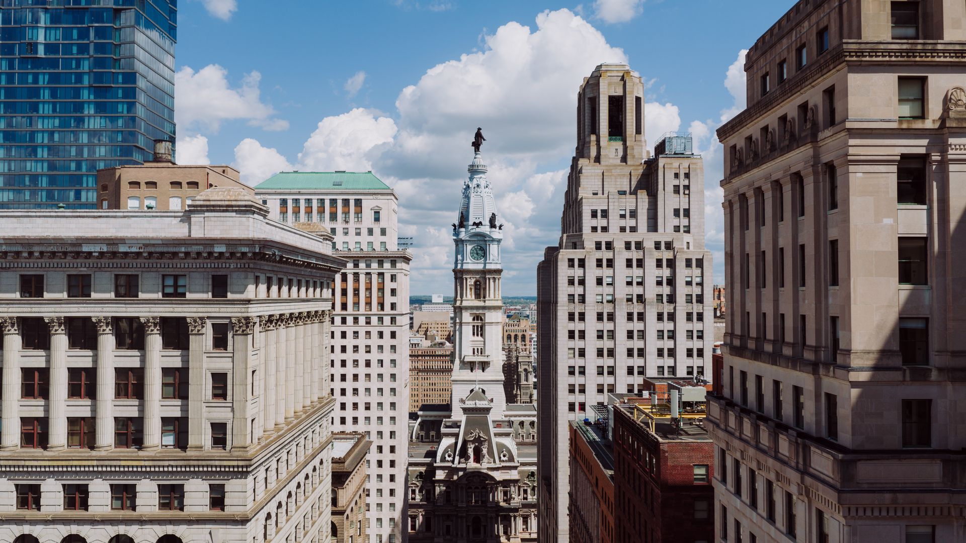 Philadelphia city hall and historic downtown architecture with blue sky and white clouds