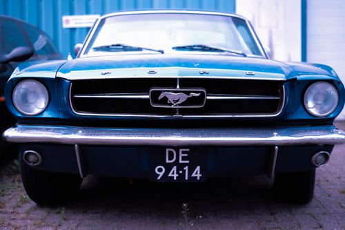 Free Front view of a classic blue Ford Mustang car parked outdoors. Stock Photo