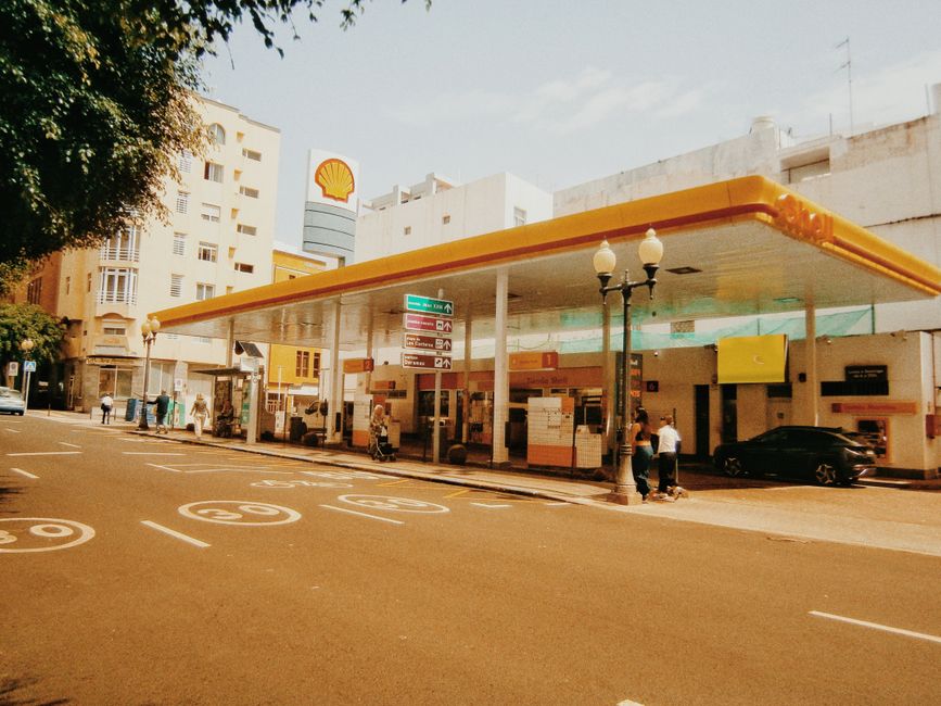 Street scene of a city gas station with a vintage filter, capturing urban architecture and daily life.