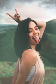 这幅有趣的肖像描绘了一位年轻女子在日落时做出摇滚手势并伸出舌头的情景