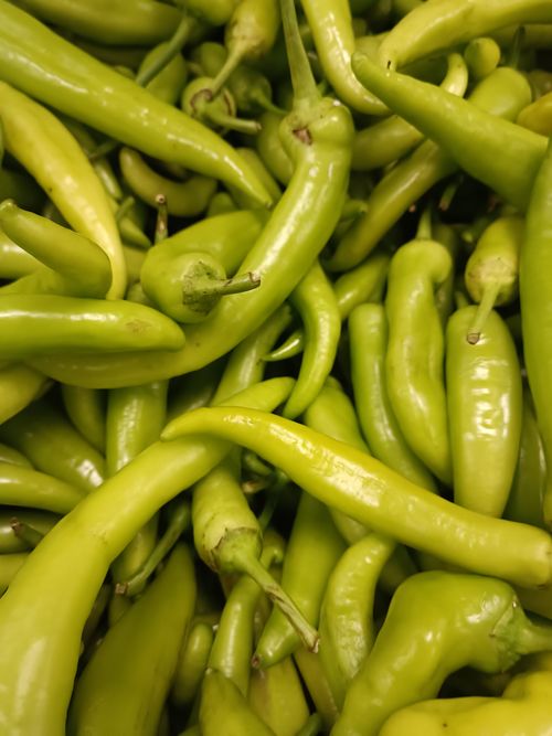 Free Close-up photo of fresh green banana peppers, highlighting their vibrant color and texture. Stock Photo