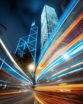 Dynamic night cityscape with neon lights and motion trails in a vibrant urban setting.