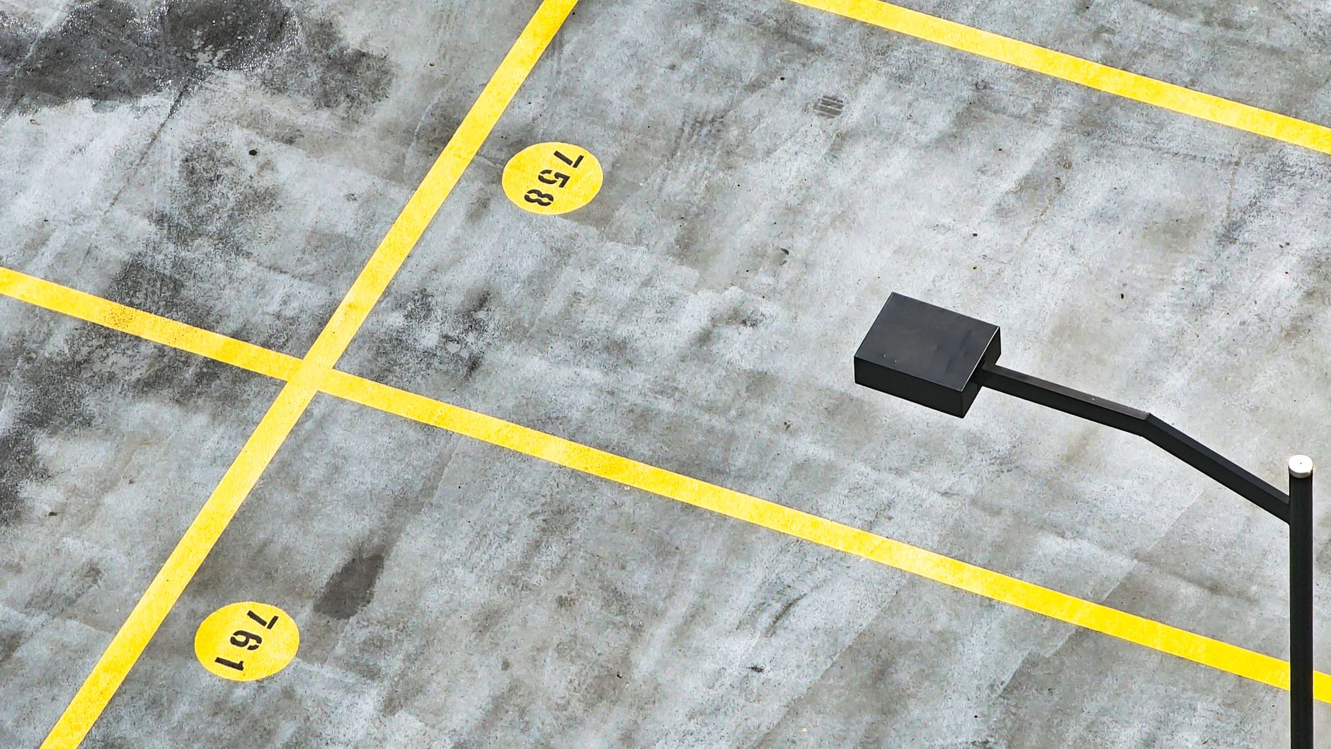 BPC 157 Peptide Review: Benefits for Americans 2 Top view of a vacant parking lot with yellow lines and street lamp.