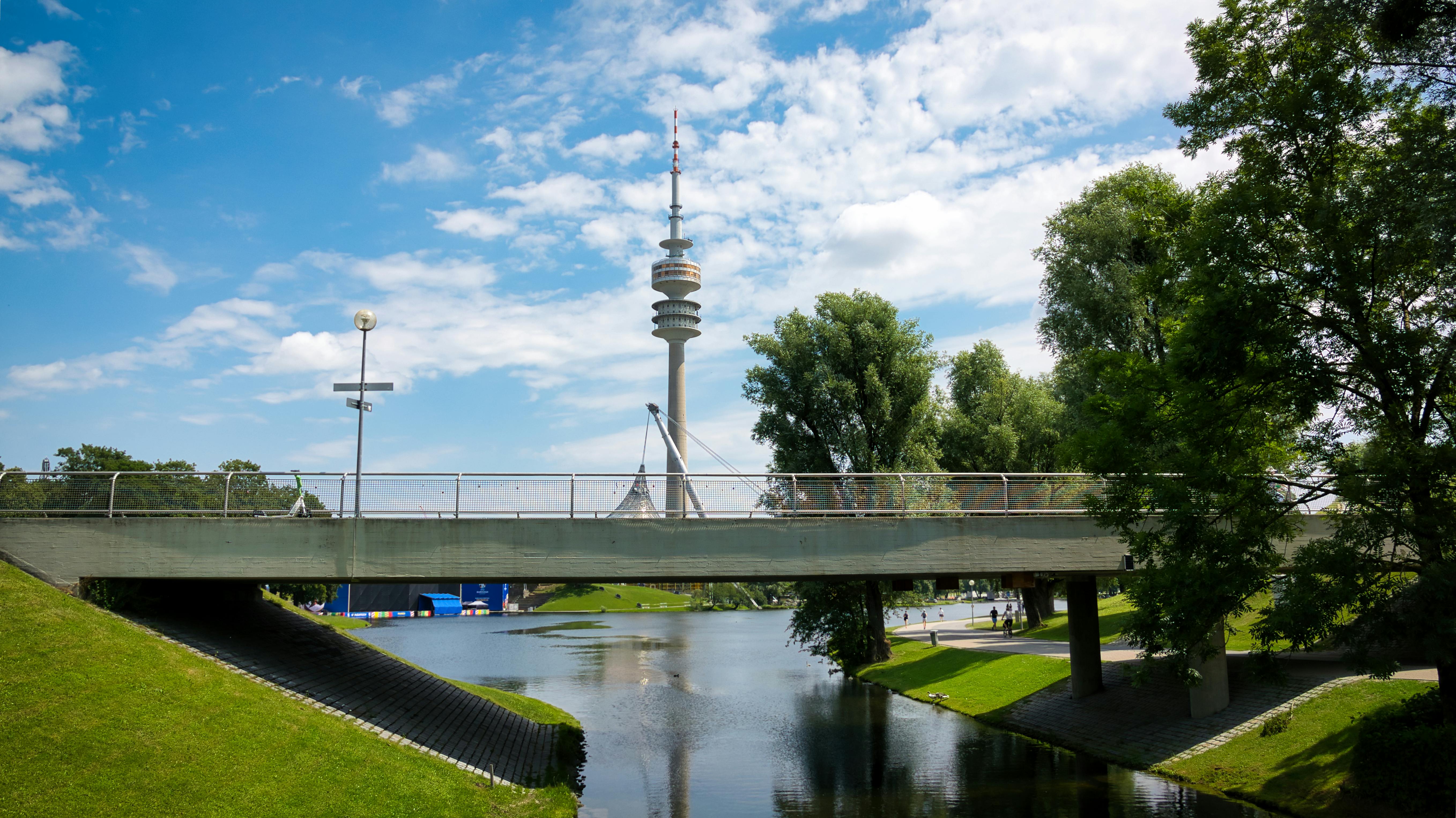 Scenic view of Olympiapark in Munich, featuring the iconic Olympic Tower on a sunny day.