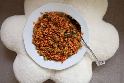 Free Top-down view of a nutritious bulgur salad with fresh vegetables served on a white plate. Stock Photo