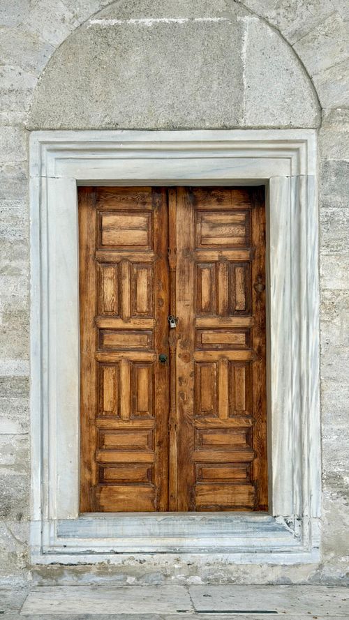Free Close-up of a classic wooden door embedded in a historic Istanbul stone archway. Stock Photo