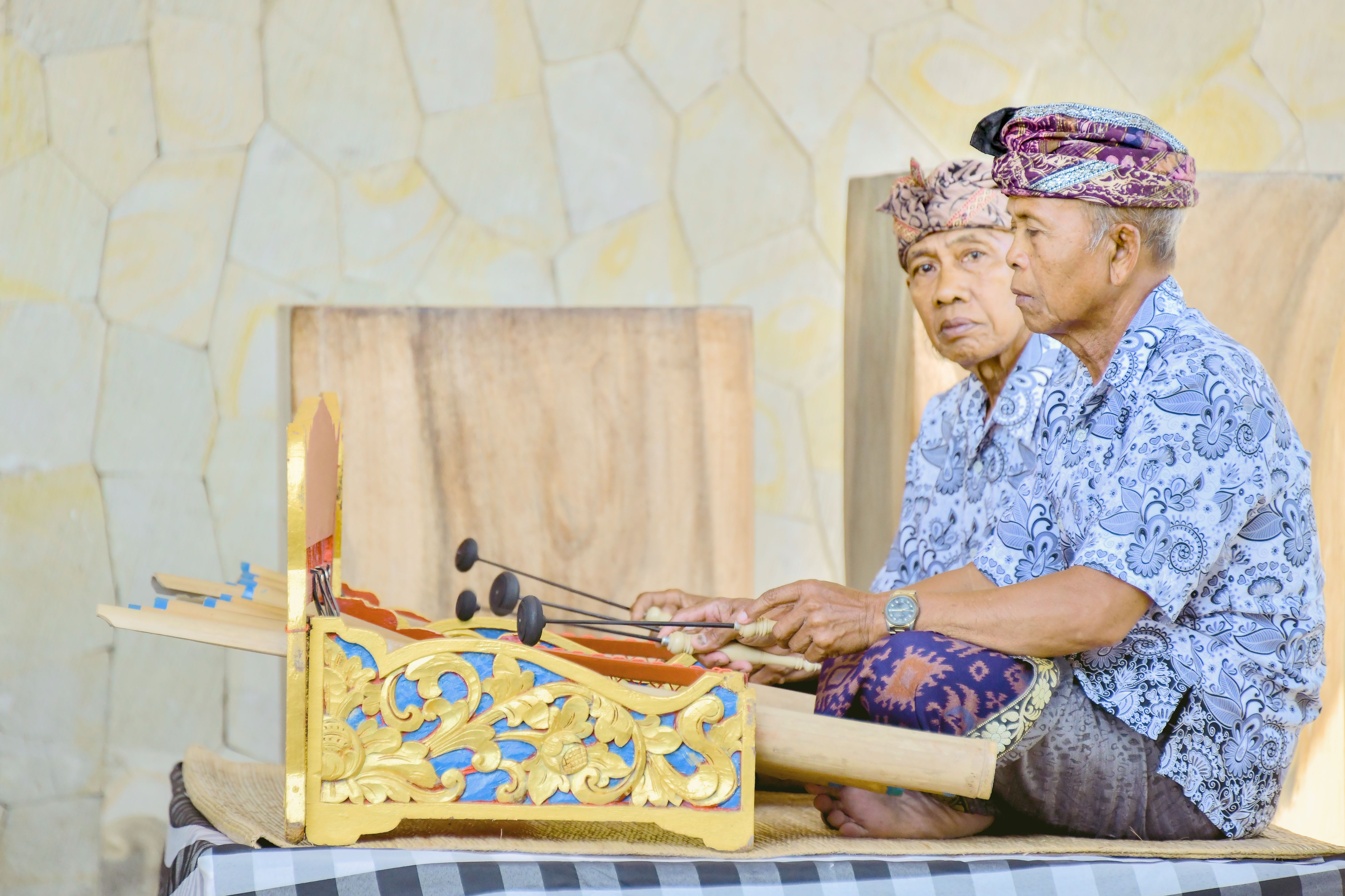 Elderly musicians playing traditional Gamelan music in Bali, showcasing rich cultural heritage.