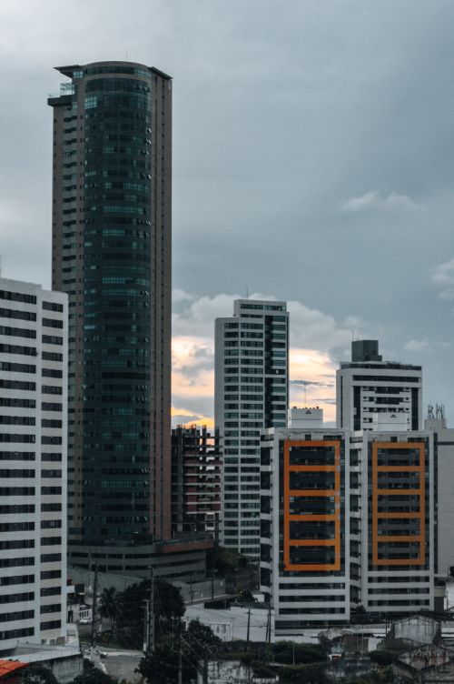 Free Skyscrapers in Natal, Brazil create an impressive cityscape under a cloudy dusk sky. Stock Photo