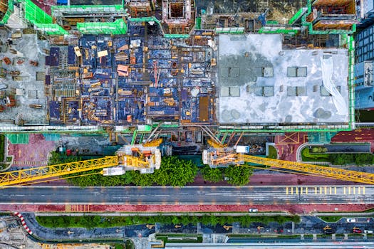 High-angle aerial view of a construction site with cranes in Petaling Jaya, Malaysia.