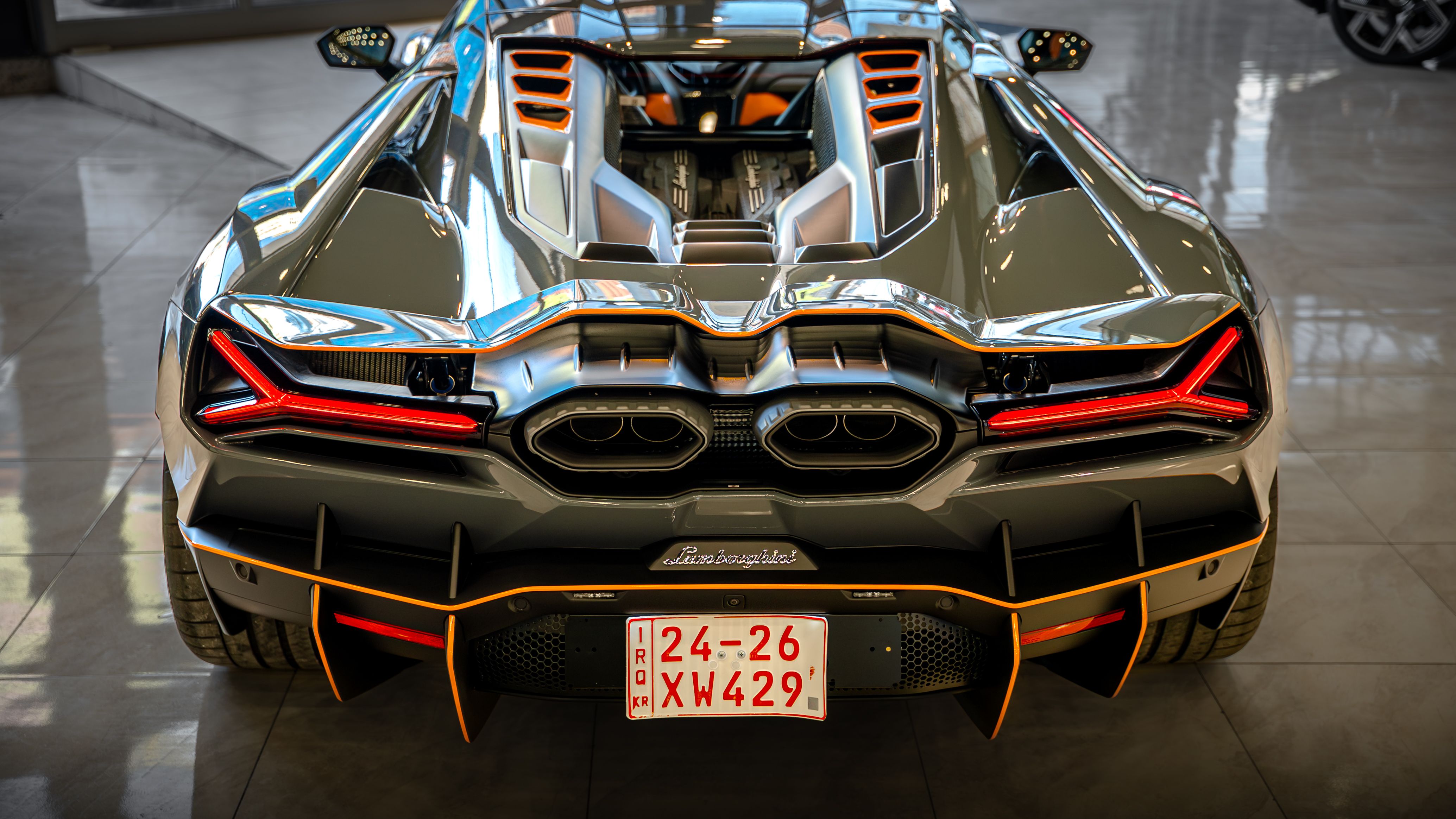 High-Performance Sports Car Rear View in Showroom · Free Stock Photo