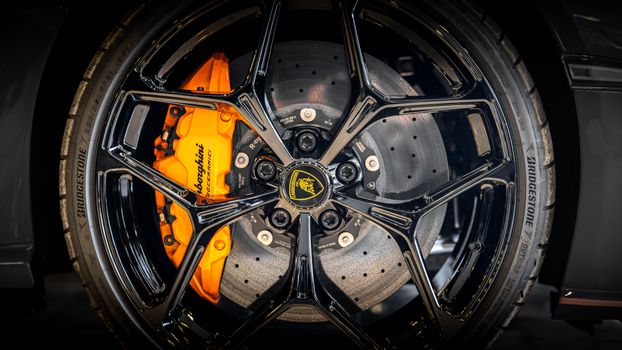 Detailed view of a luxury car's wheel with visible brake disc and caliper highlighting performance.