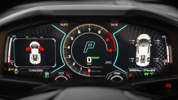 Close-up of a modern car dashboard showing digital speedometer and control indicators.