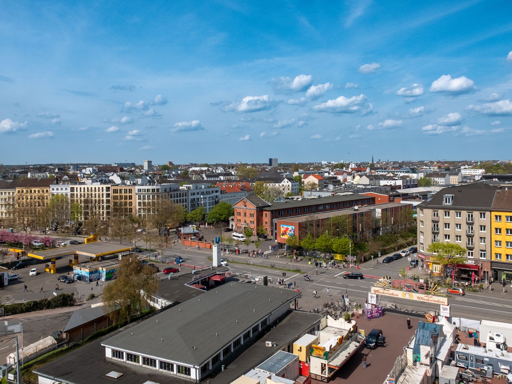 Urban cityscape view with buildings and clear sky, captured from above.