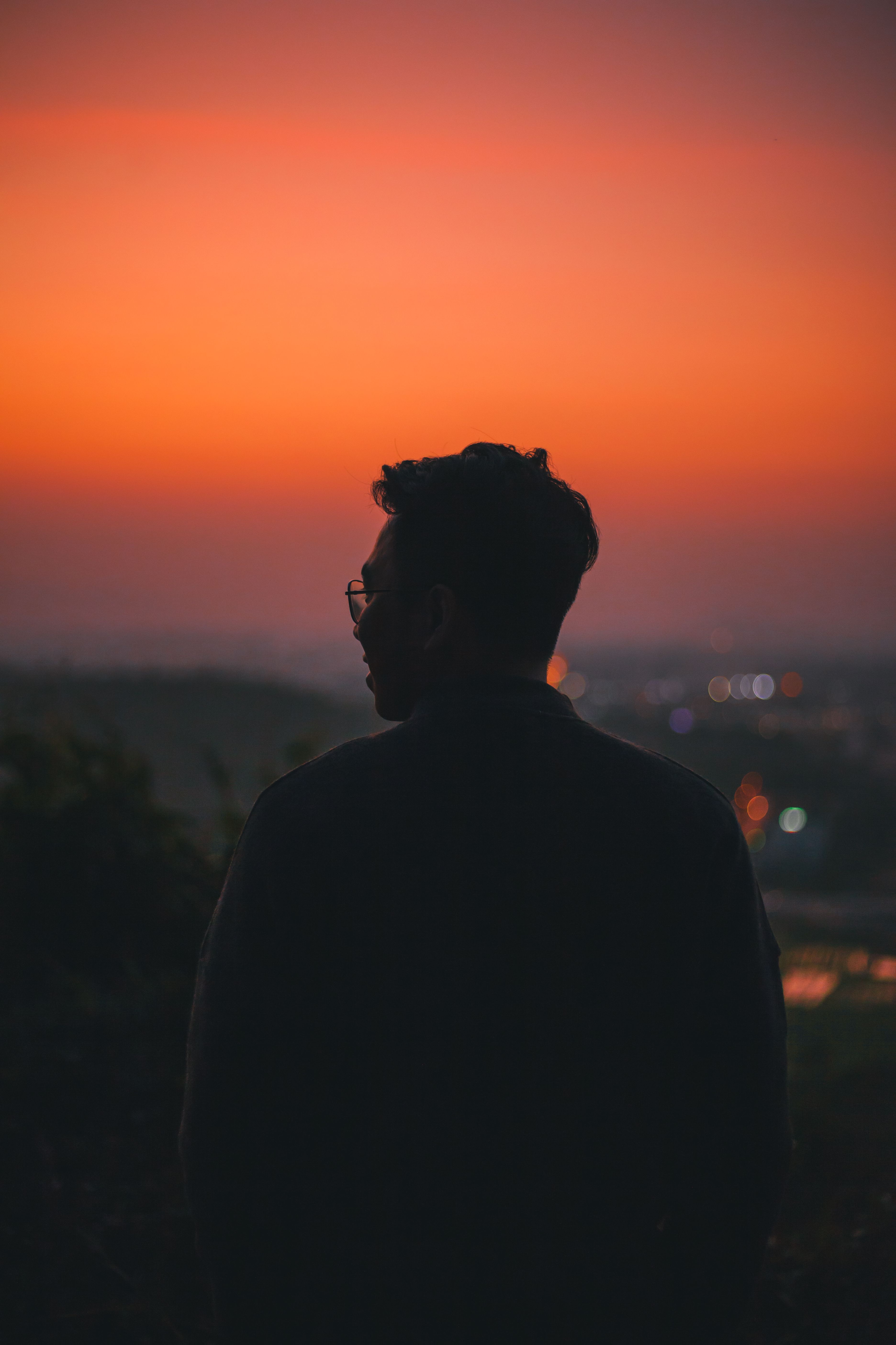 silhouette-of-man-wearing-eyeglasses-standing-during-sunset-free