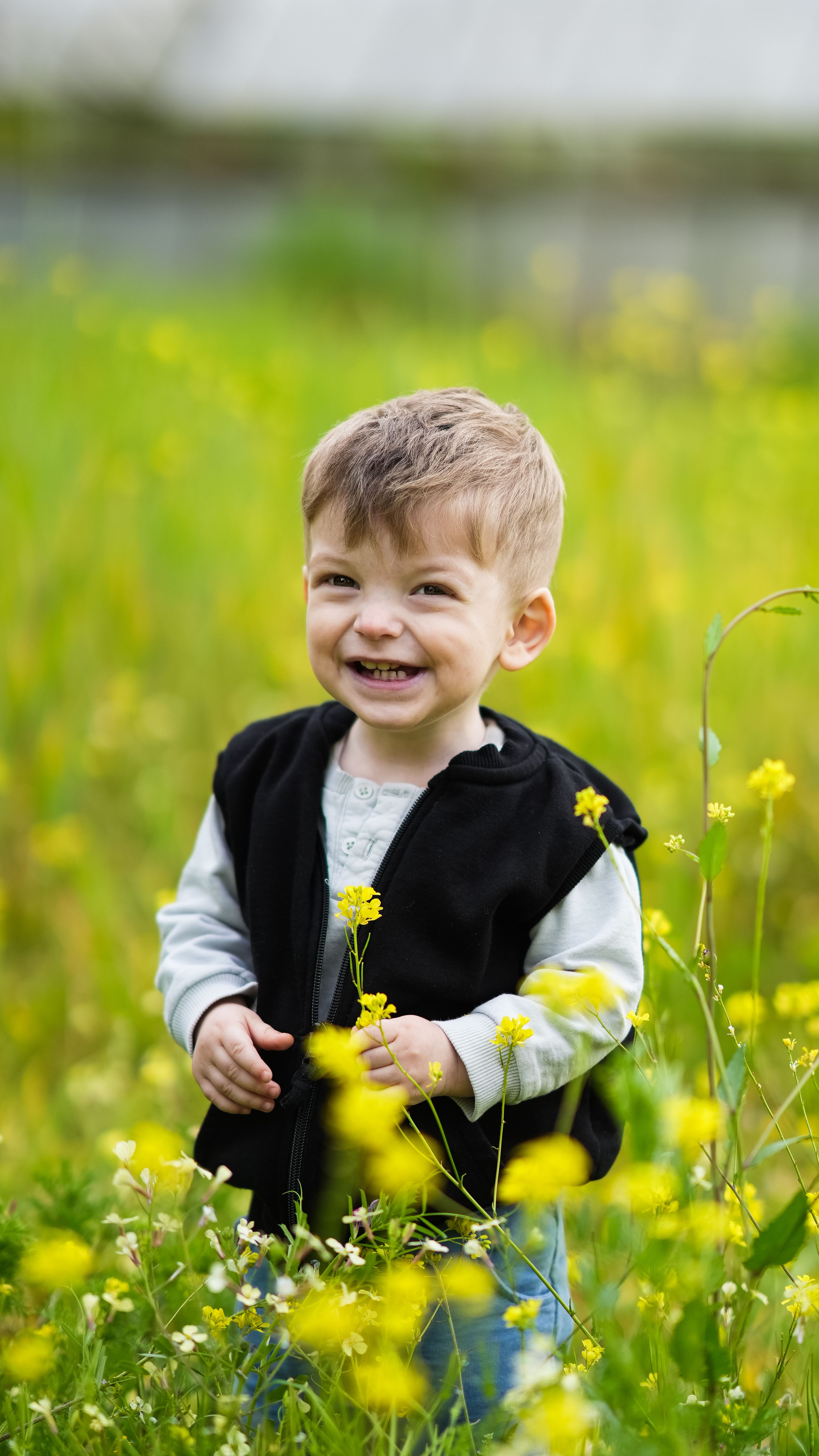 Smiling Child in Blooming Spring Meadow · Free Stock Photo
