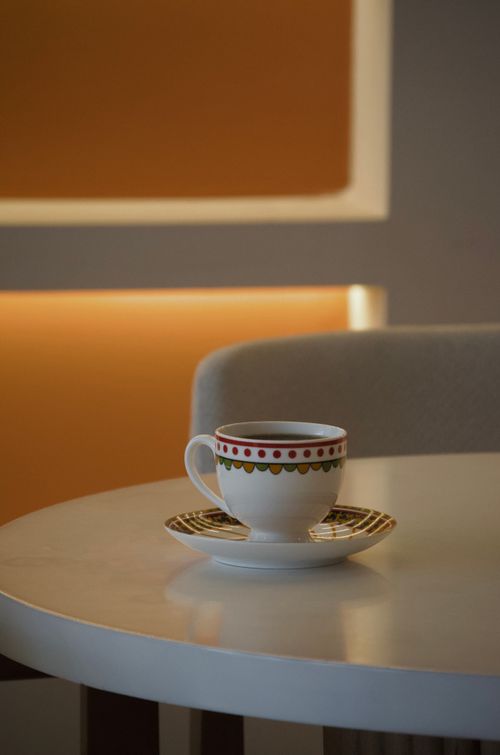 Free A beautifully designed teacup sitting on a modern café table with ambient lighting in Türkiye. Stock Photo