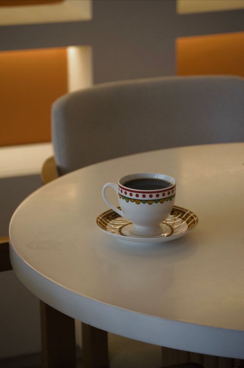 Free Artistic view of a coffee cup on a round table in a modern Turkish cafe setting. Stock Photo