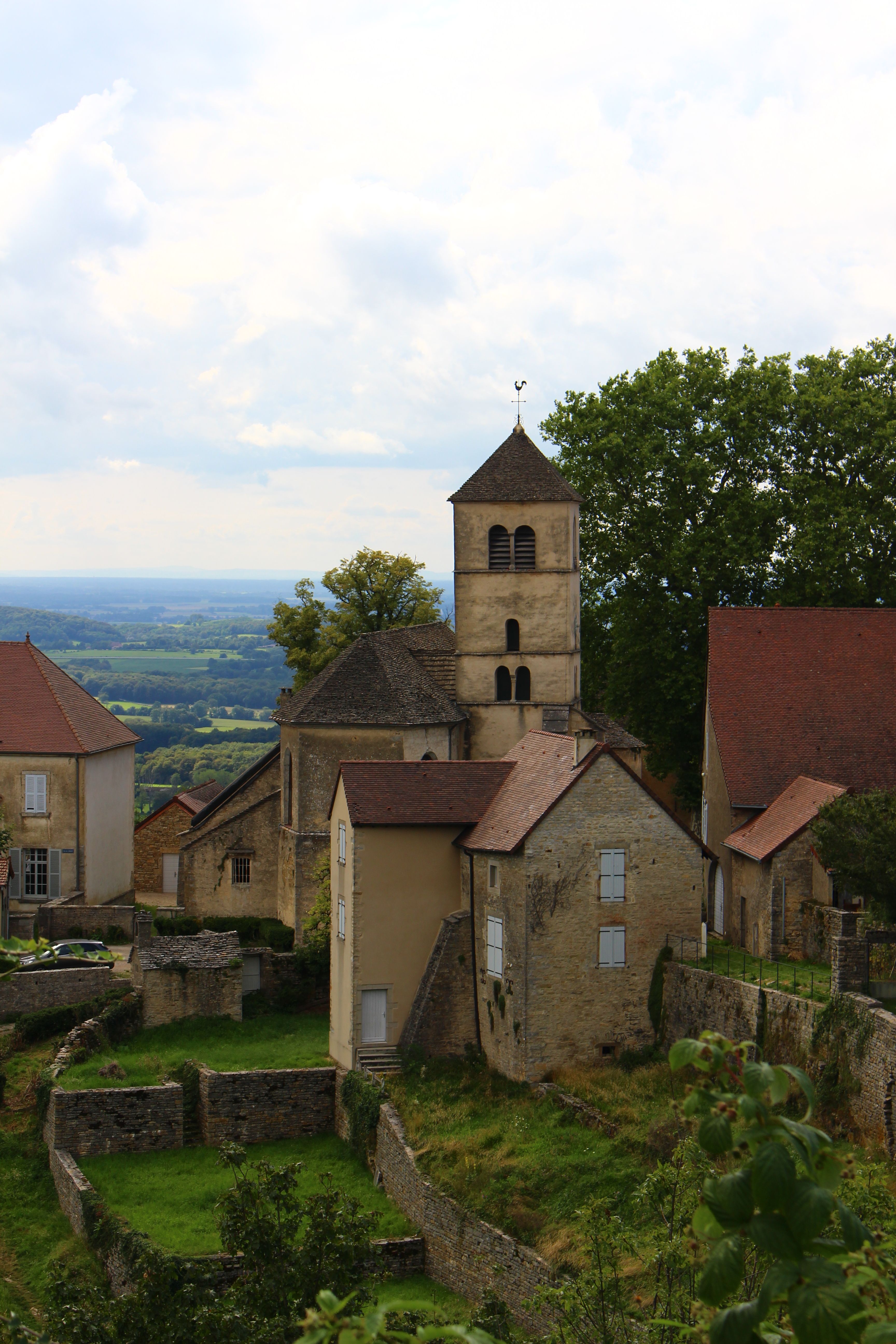 Idyllic view of a church in a quaint French village surrounded by lush countryside.