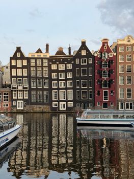 Beautiful view of iconic canal houses along Amsterdam's waterways, reflecting the city's unique architectural style.